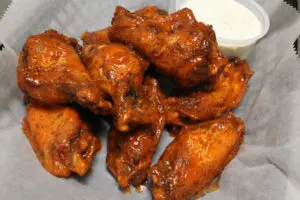 A close up of some chicken wings on a plate