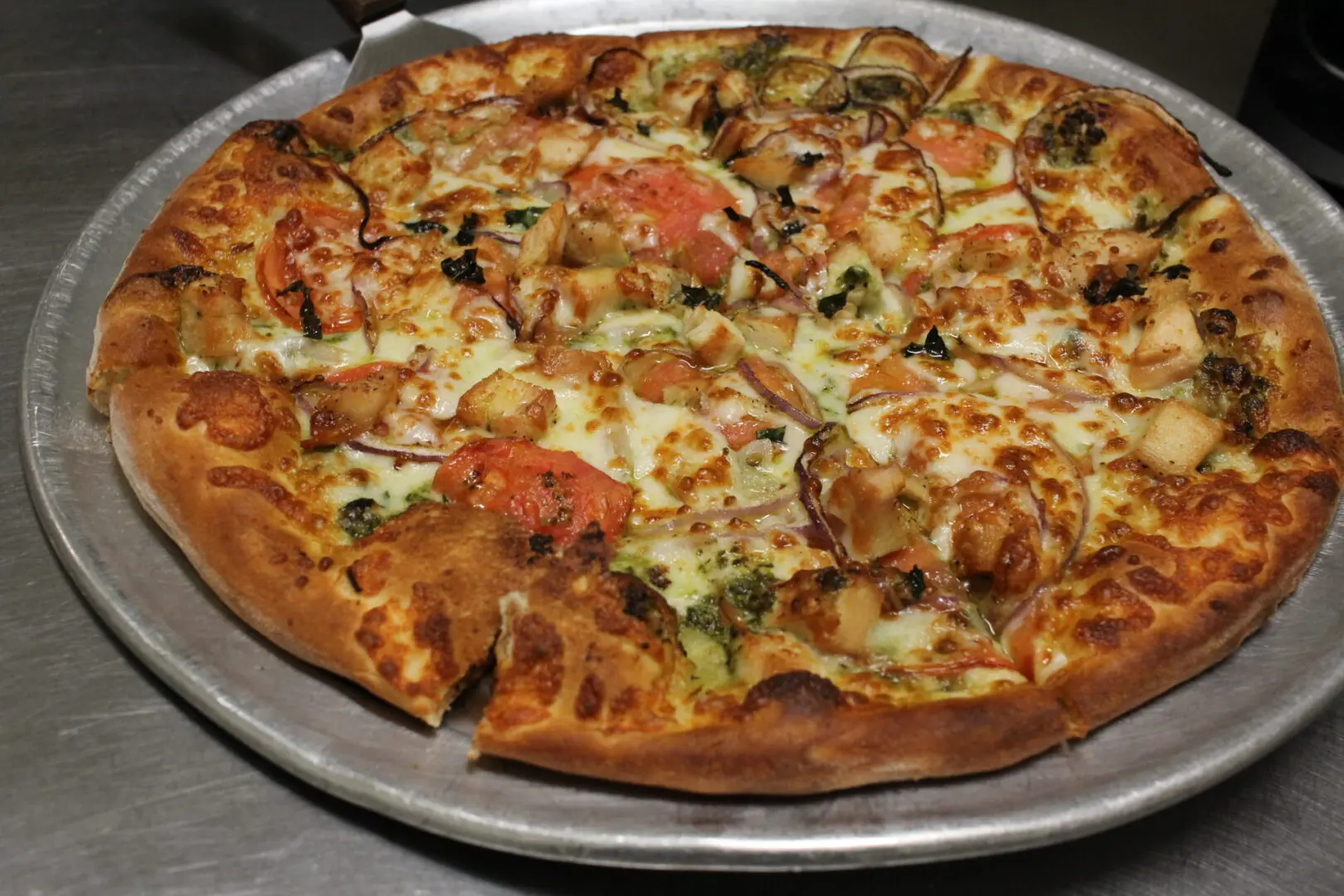 A pizza sitting on top of a pan covered in cheese.